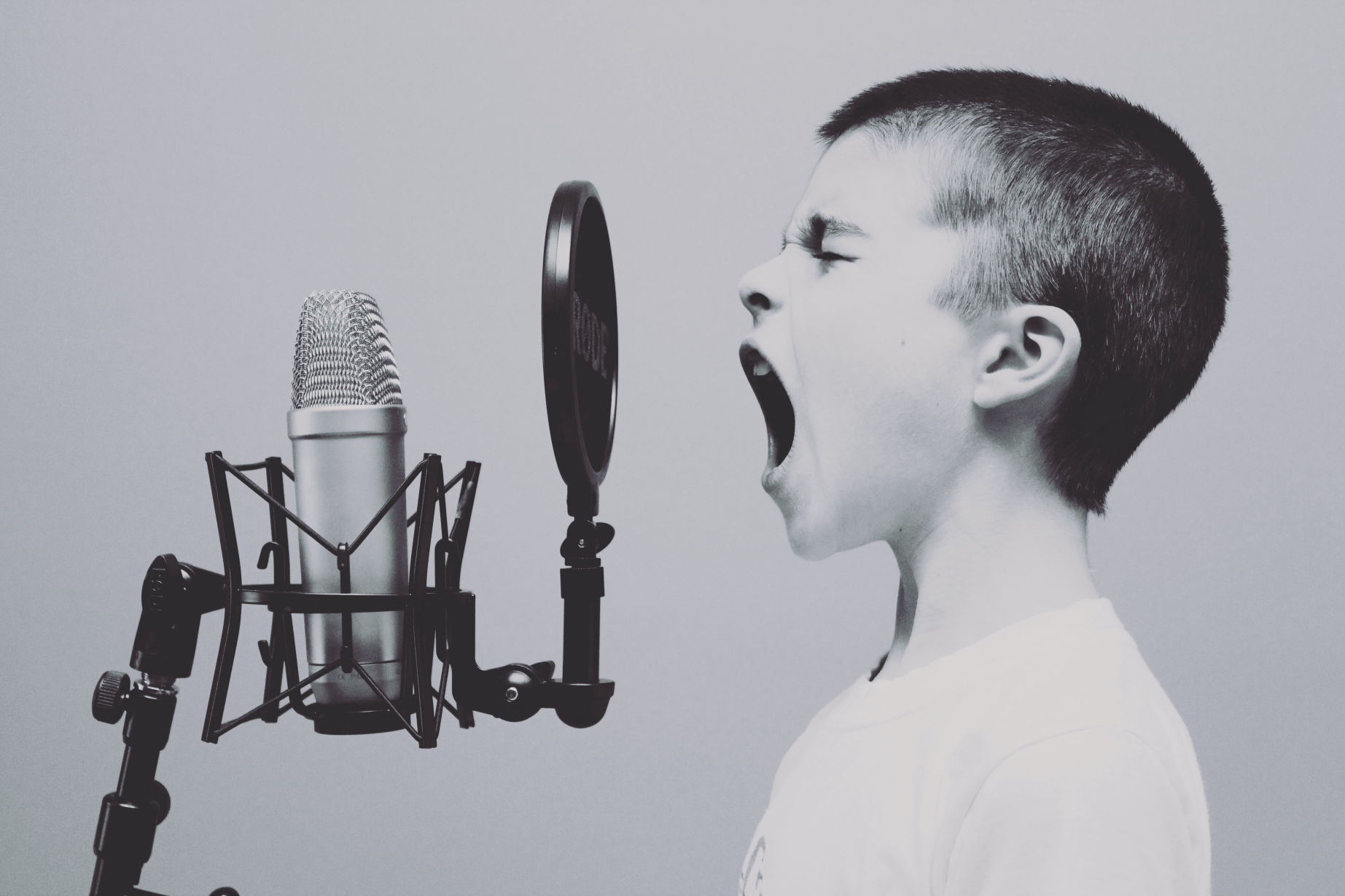 Boy shouting into microphone